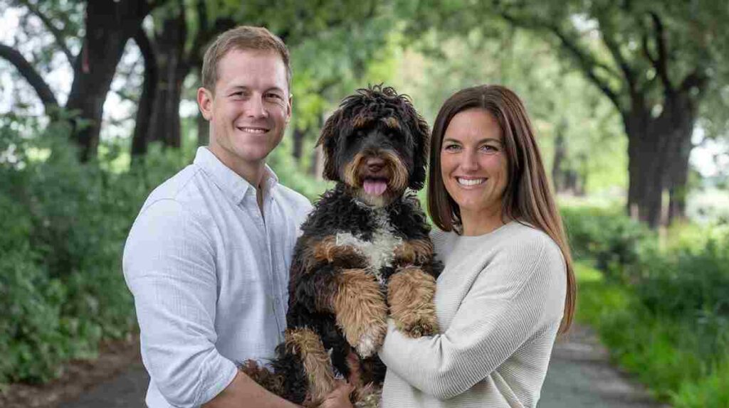 A photo of CEO of Bernedoodle Nation with a dog